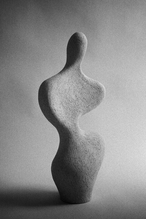 abstract sculpture with flower in vase
