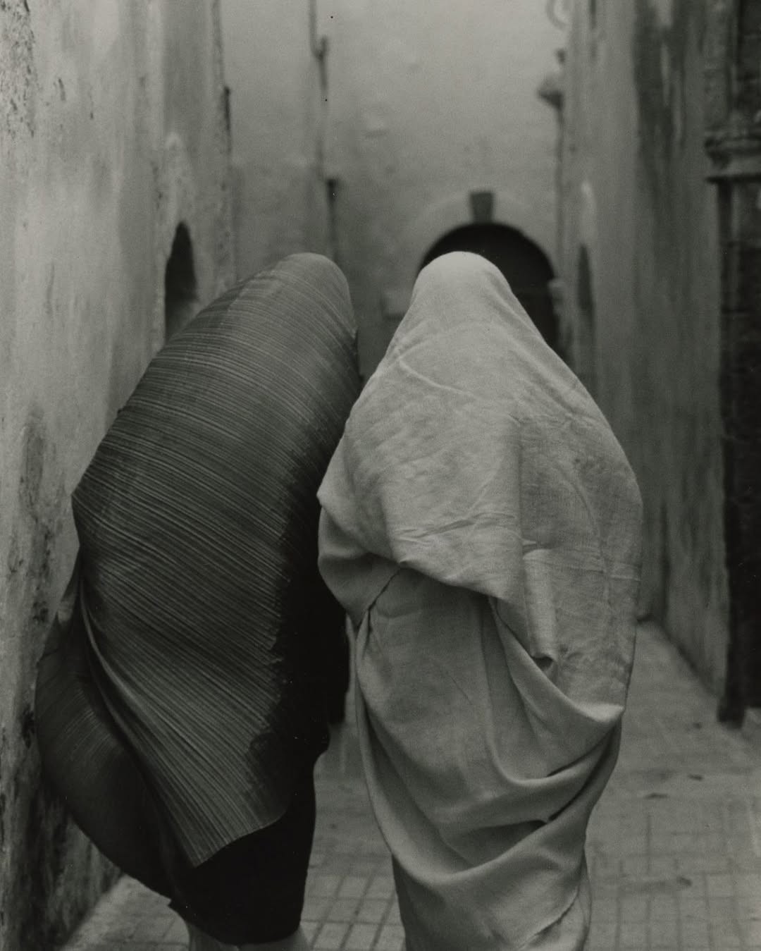 photograph of man holding balloons