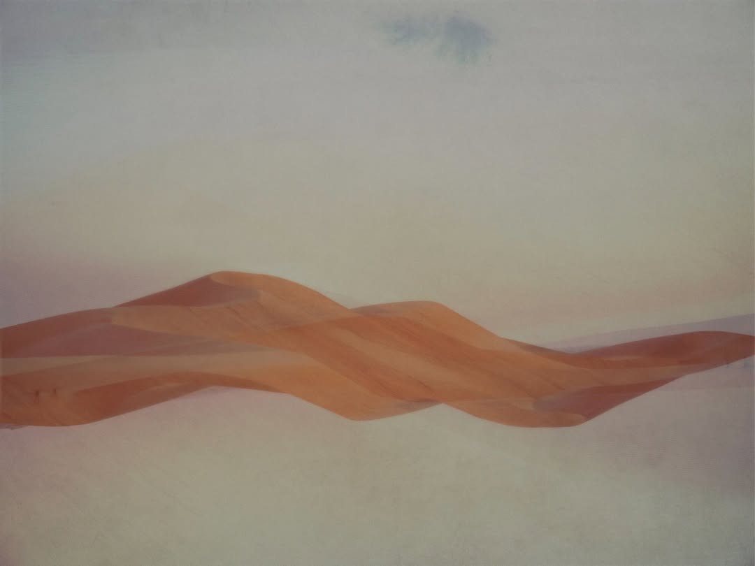 photograph of man holding balloons