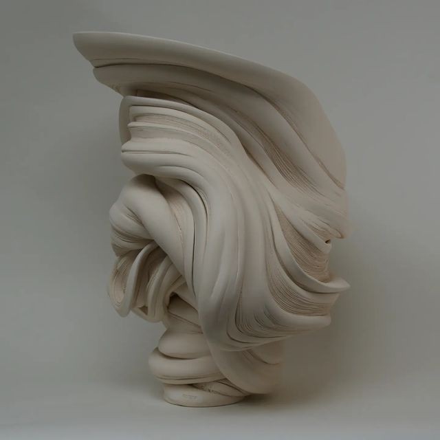 abstract sculpture with flower in vase