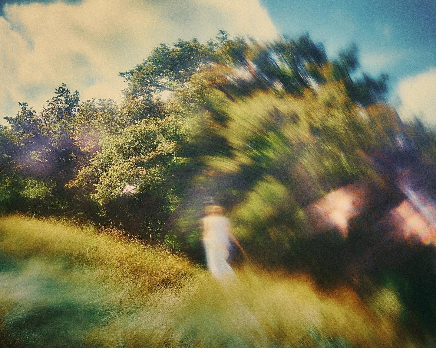 photograph of man holding balloons